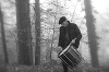 A drummer practicing in the woods